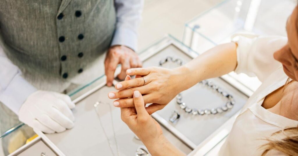 Woman putting a ring on layaway